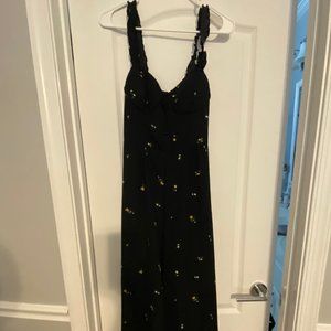 Black jumpsuit with yellow follows